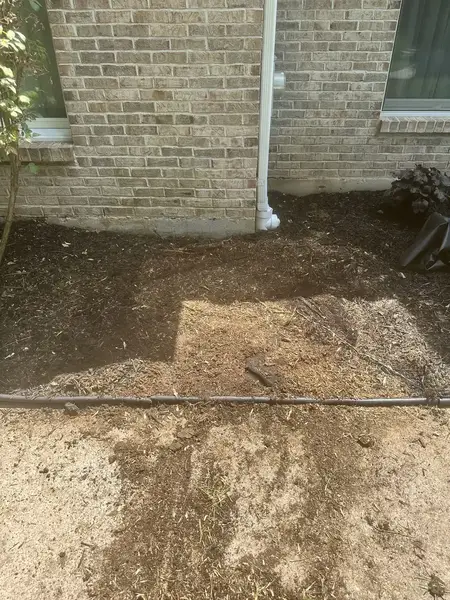 Ground-out area by a brick wall