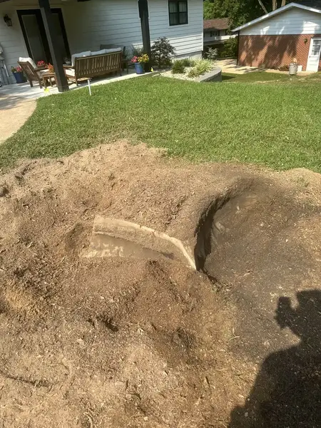 Deep hole being ground out near a house
