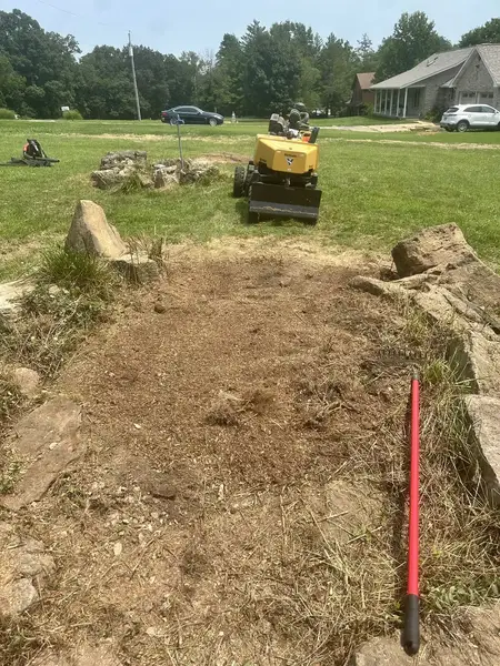 Ground-out area between large rocks with the grinder behind it