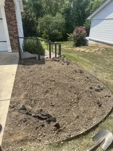 Ground-out mulch bed by a garage