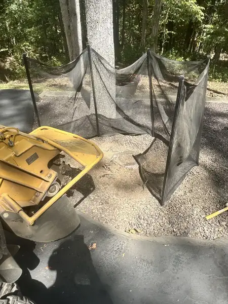 Stump grinder in a gravel bed with a safety screen