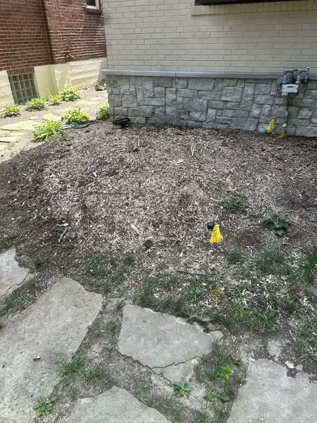 Ground-out bed by a stone foundation